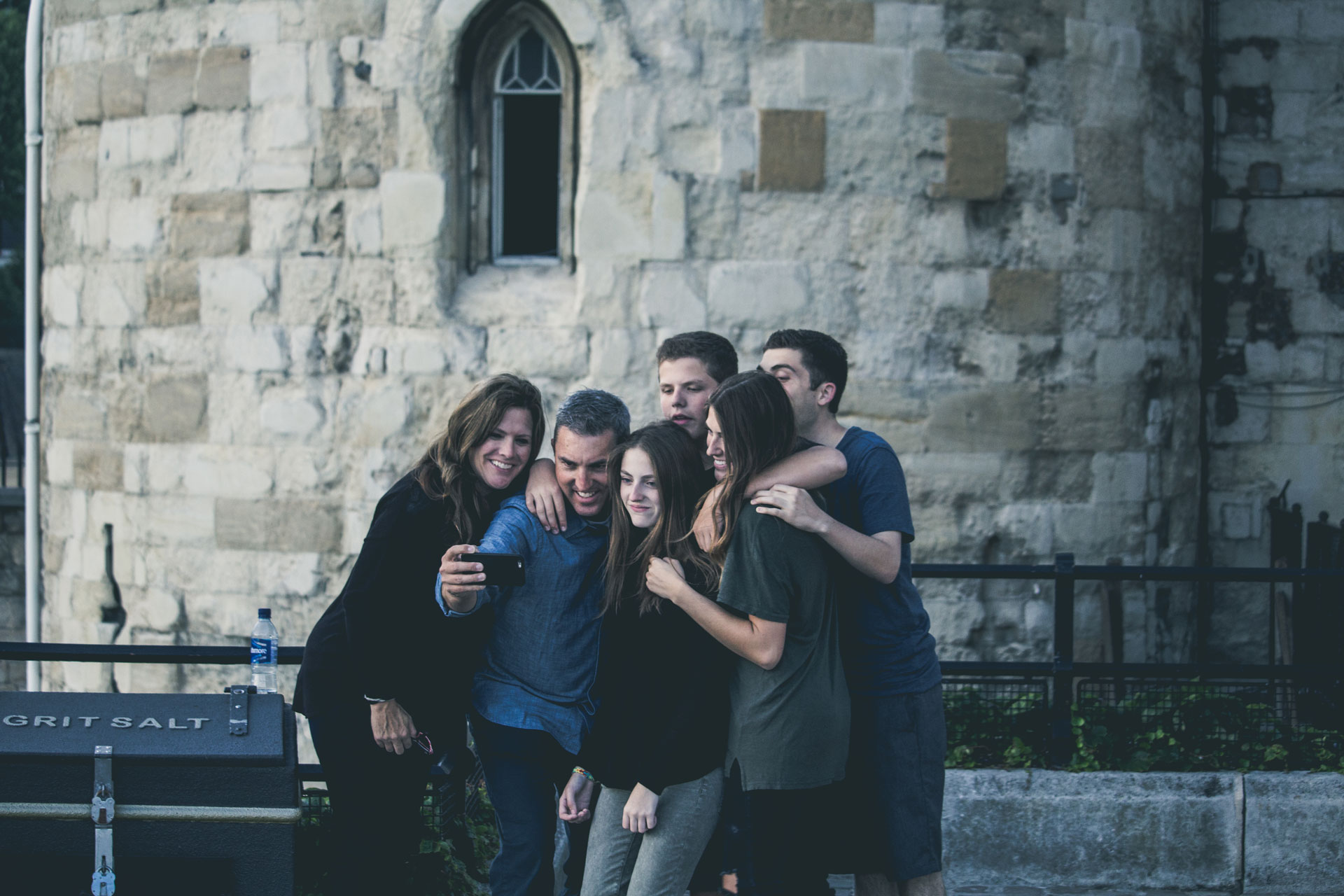 people taking a picture outside a castle