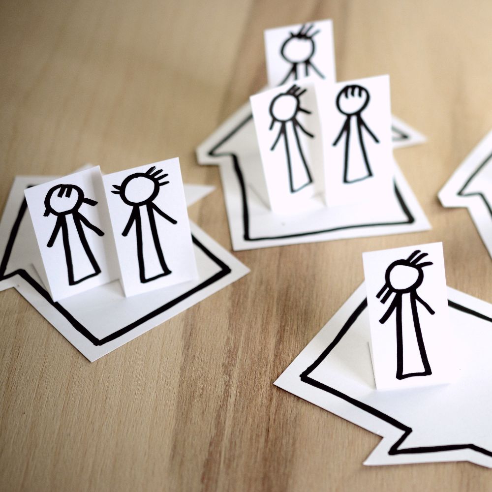 cut outs of stick people on a table